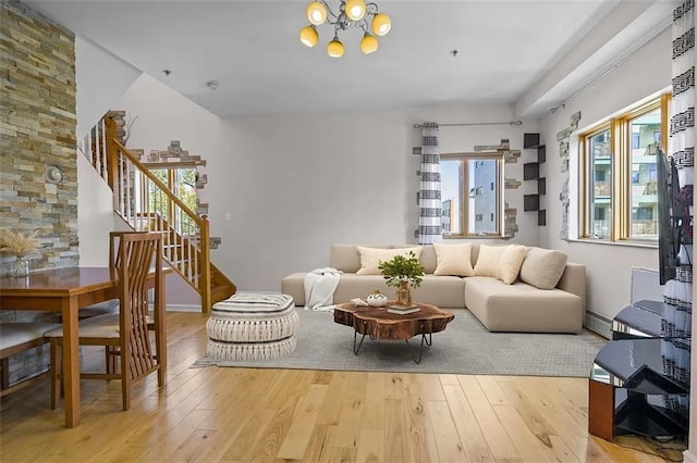 living room featuring light hardwood / wood-style flooring, a baseboard radiator, and plenty of natural light