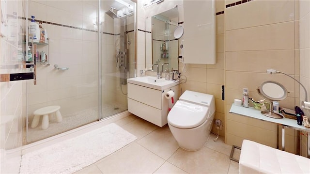 bathroom featuring tile walls, toilet, vanity, an enclosed shower, and tile patterned flooring