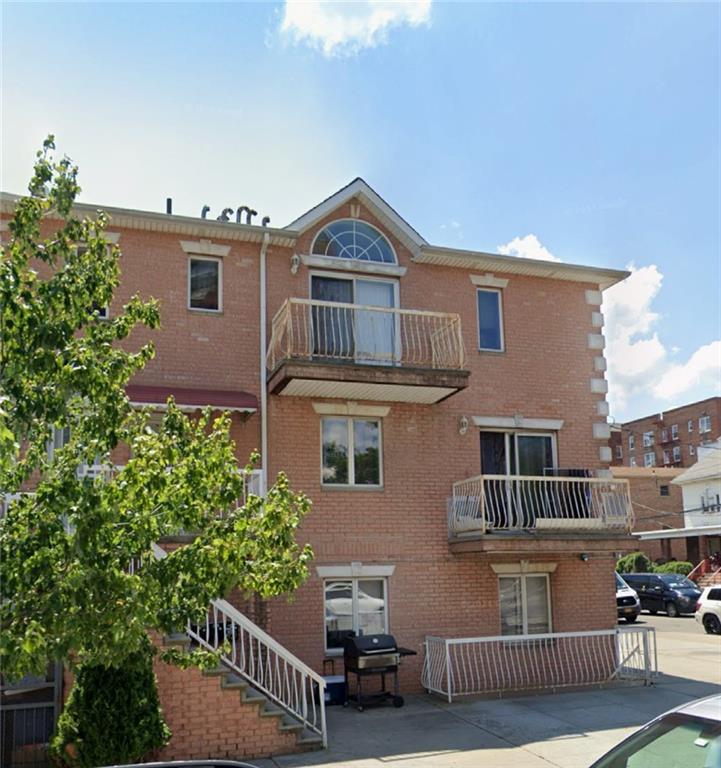 back of house featuring a balcony