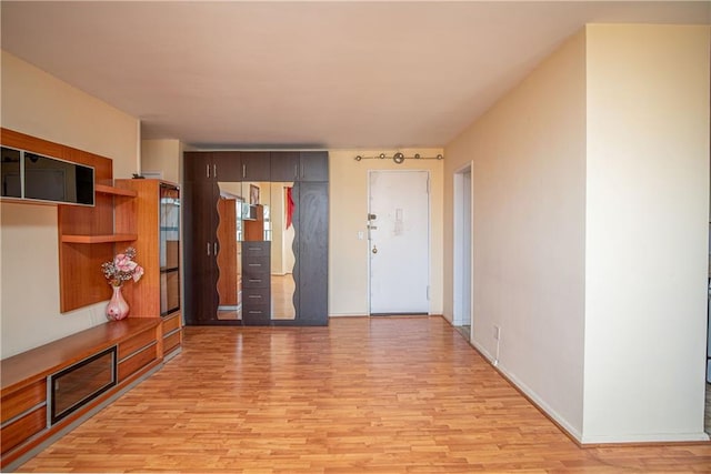 hallway with light hardwood / wood-style floors