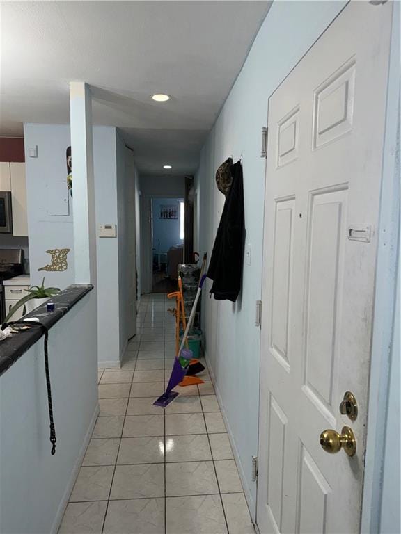 corridor with light tile patterned flooring