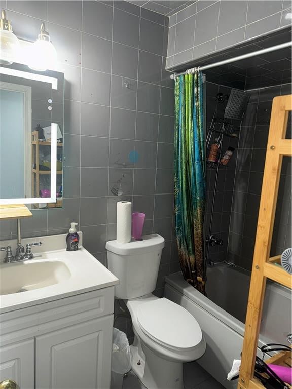 full bathroom with vanity, tile walls, toilet, and shower / bathtub combination with curtain