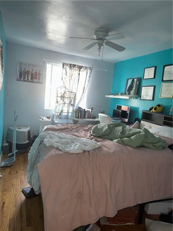 bedroom with hardwood / wood-style floors and ceiling fan