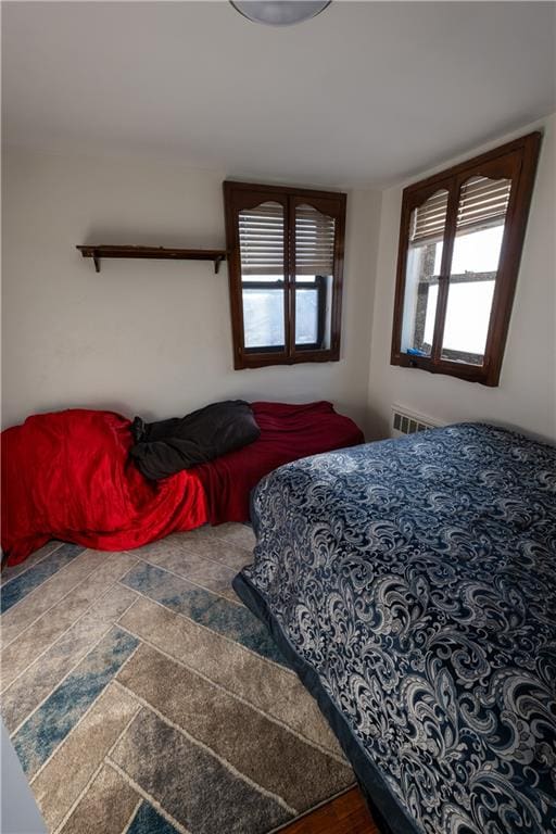 bedroom featuring stone finish flooring