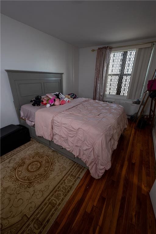 bedroom featuring dark wood-style flooring