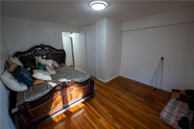 bedroom with baseboards and wood finished floors