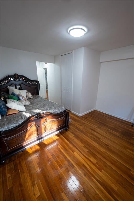 bedroom featuring baseboards and hardwood / wood-style floors