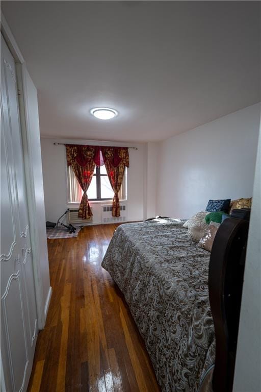 bedroom with dark wood-style floors