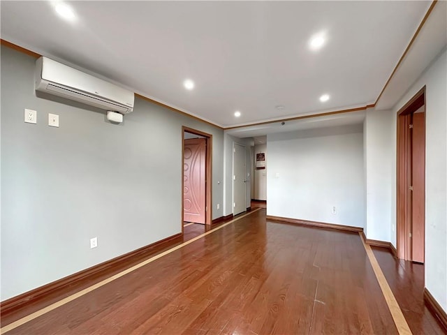 spare room featuring dark hardwood / wood-style floors and a wall mounted air conditioner