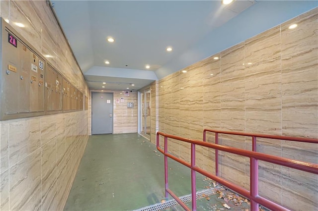 corridor with elevator and mail boxes