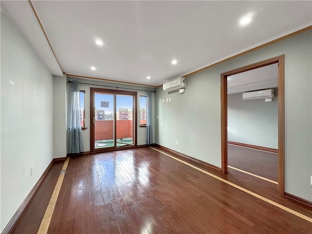 empty room featuring a wall mounted air conditioner and dark hardwood / wood-style floors