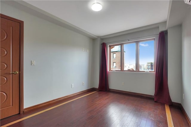 empty room with dark wood-type flooring