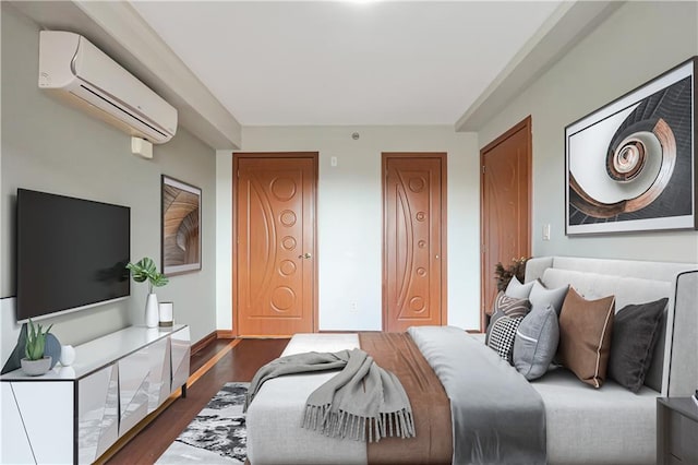 bedroom with dark hardwood / wood-style floors and a wall unit AC