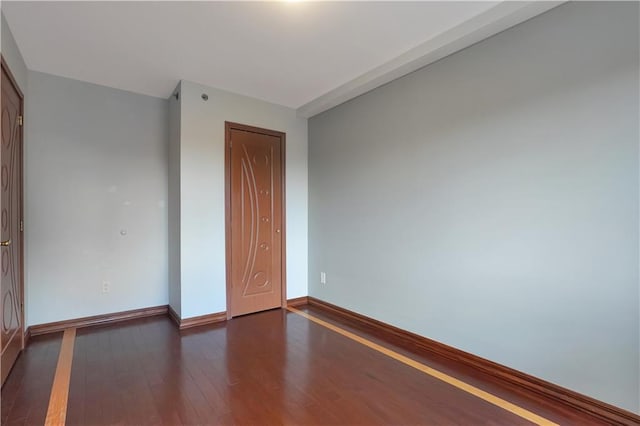 unfurnished bedroom with dark hardwood / wood-style floors