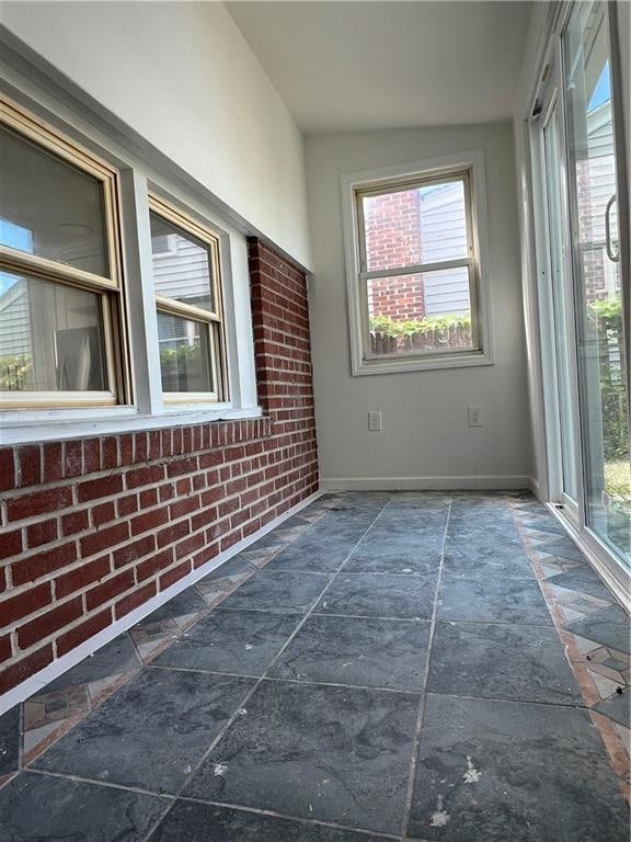 unfurnished sunroom featuring a wealth of natural light