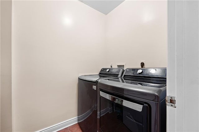 laundry area with washer and dryer and tile patterned floors