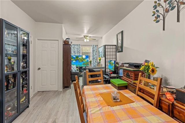 dining room with hardwood / wood-style floors and ceiling fan