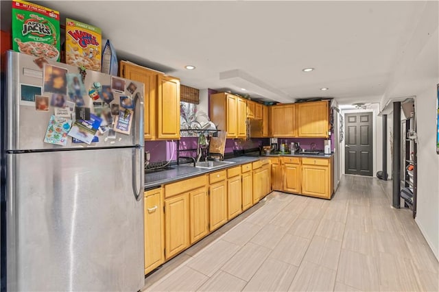 kitchen with sink and stainless steel refrigerator