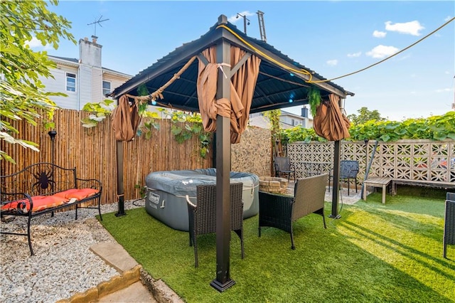 view of patio / terrace featuring a gazebo and a hot tub