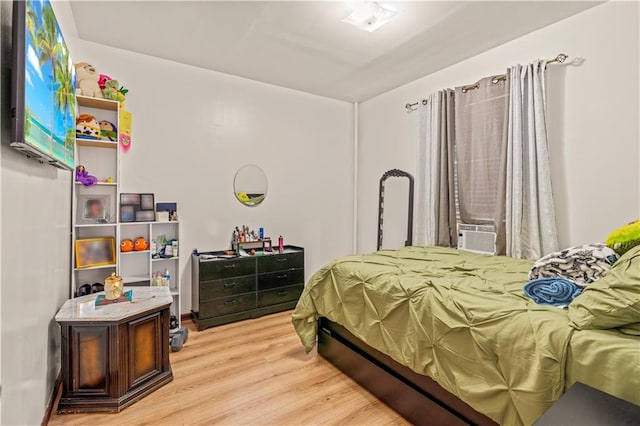 bedroom featuring cooling unit and light wood-type flooring