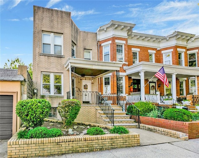 view of front of house featuring brick siding and a porch