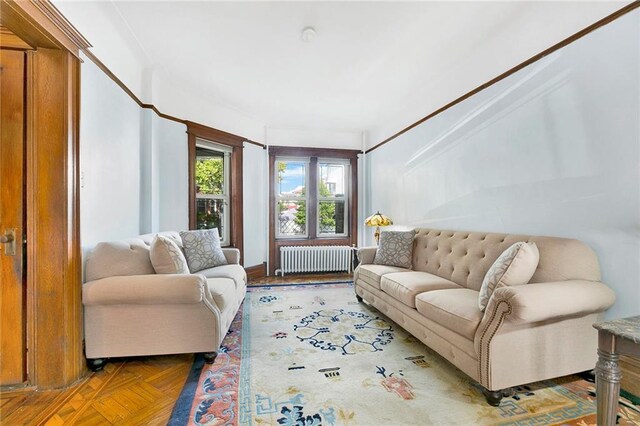 living room featuring parquet flooring and radiator heating unit