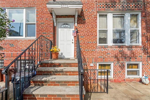 doorway to property with brick siding