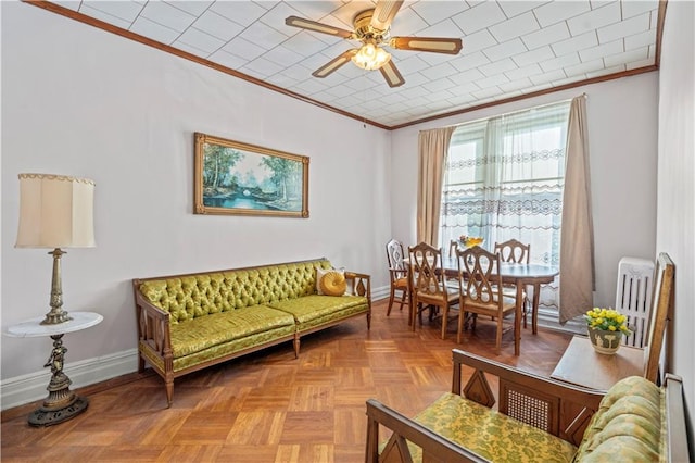 living room featuring crown molding, ceiling fan, and light parquet flooring