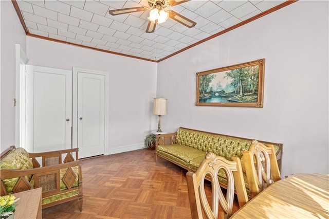 living room with ceiling fan, ornamental molding, and light parquet flooring