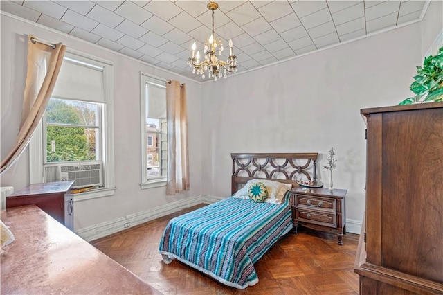 bedroom with cooling unit, crown molding, dark parquet floors, and a chandelier