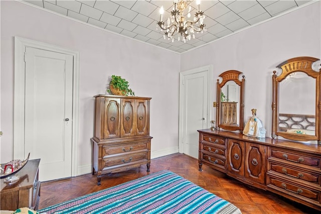 bedroom featuring dark parquet flooring and a notable chandelier