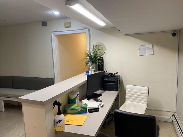 tiled office with a baseboard heating unit