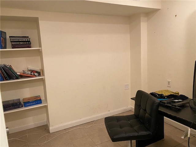 tiled office space featuring built in shelves