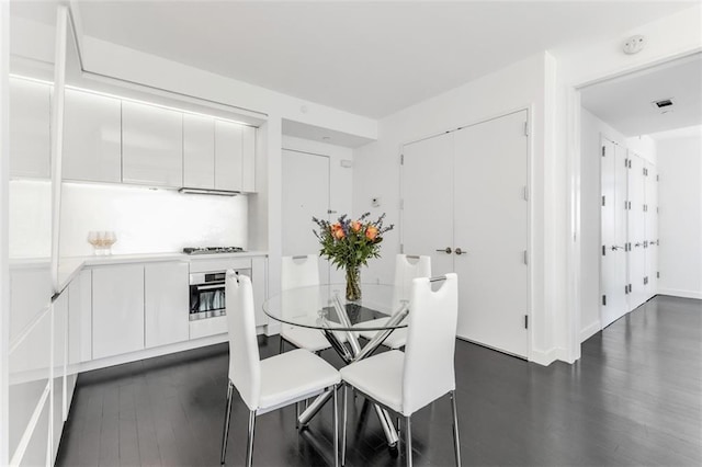 dining area featuring dark hardwood / wood-style flooring