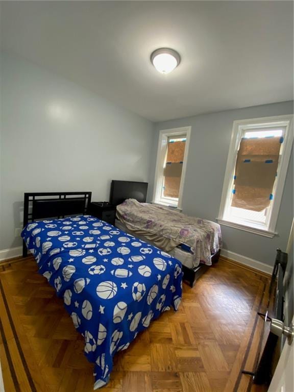 bedroom featuring dark parquet floors