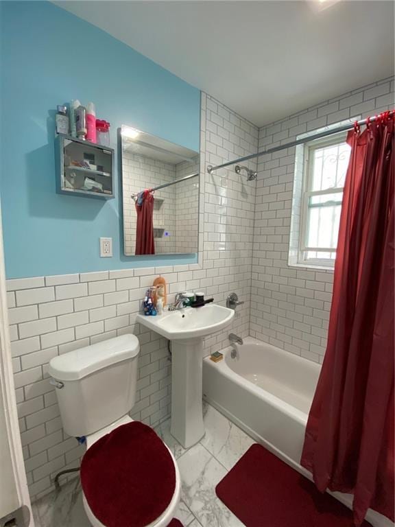 full bathroom with sink, shower / bath combo with shower curtain, tile walls, and toilet