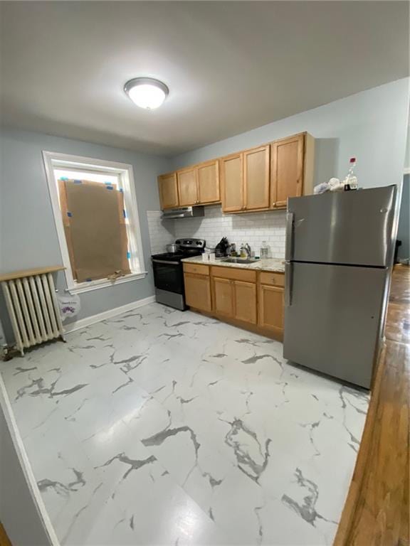 kitchen featuring black range with electric stovetop, radiator, sink, tasteful backsplash, and stainless steel fridge