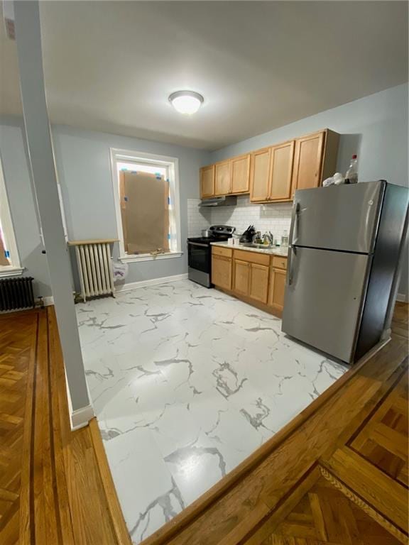 kitchen featuring decorative backsplash, stainless steel fridge, sink, radiator heating unit, and black range with electric stovetop