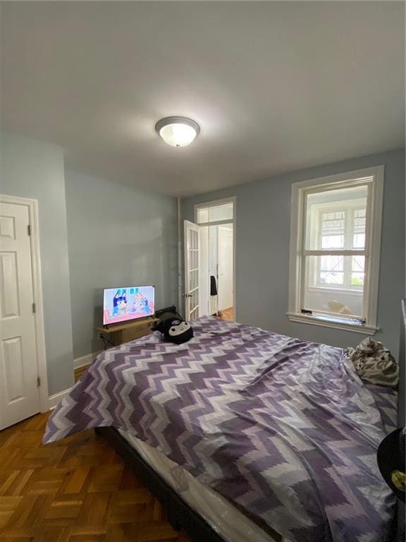 bedroom with dark parquet flooring