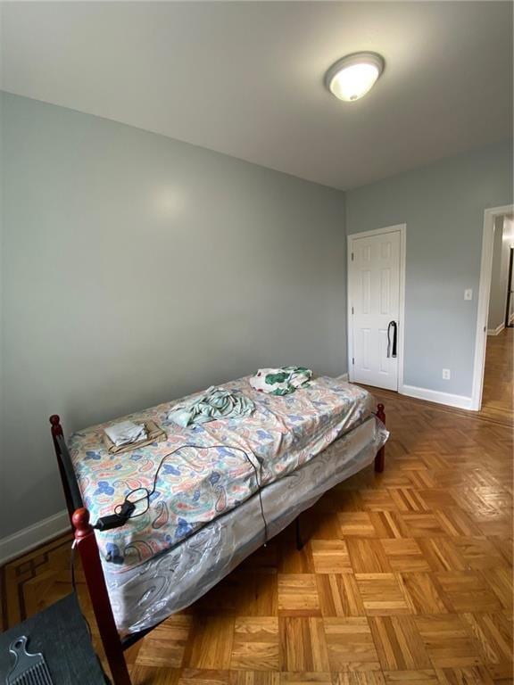 bedroom with light parquet flooring