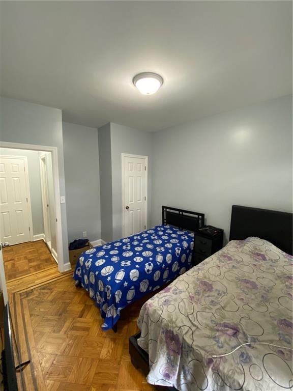 bedroom featuring parquet flooring