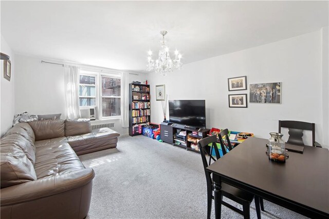 living room with carpet and an inviting chandelier