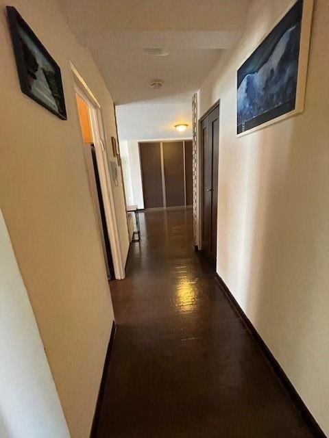 hallway with dark wood-type flooring