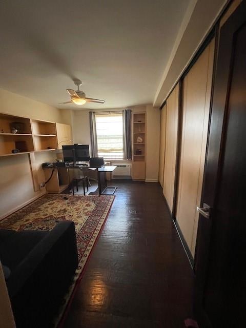 living room with ceiling fan and dark hardwood / wood-style floors