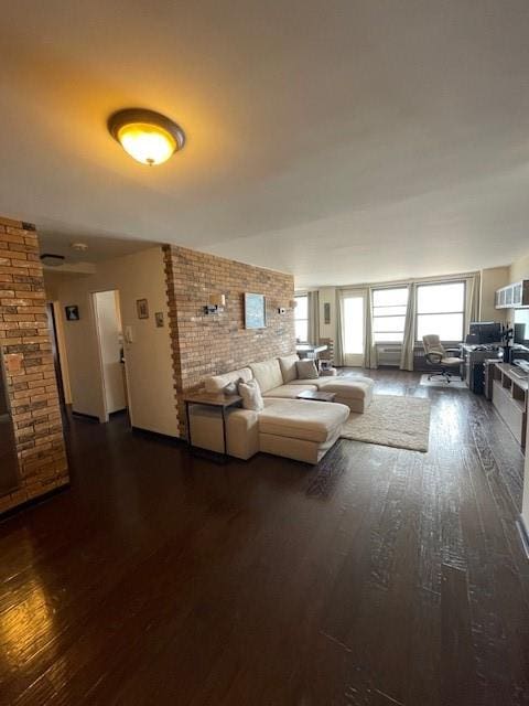 unfurnished living room with dark wood-type flooring