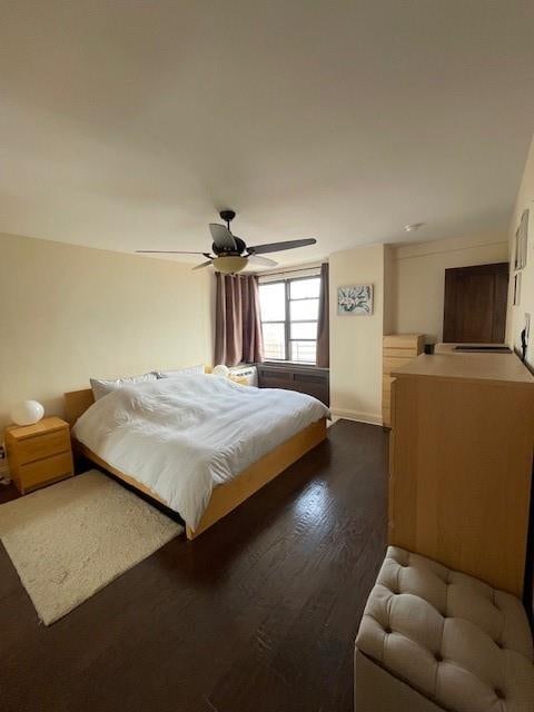 bedroom featuring ceiling fan and dark wood-type flooring