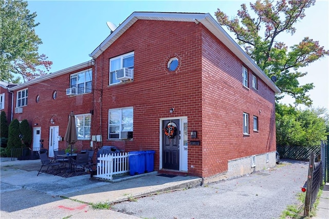 view of front of home featuring cooling unit and a patio