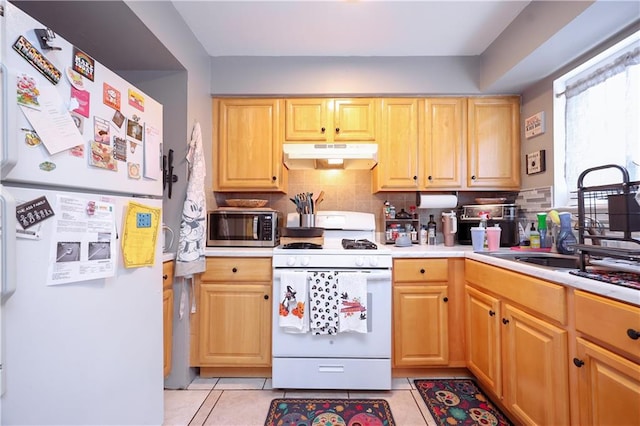 kitchen with light brown cabinets, backsplash, light tile patterned floors, and white appliances