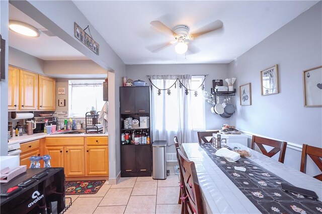 kitchen featuring tile counters, light tile patterned floors, and ceiling fan