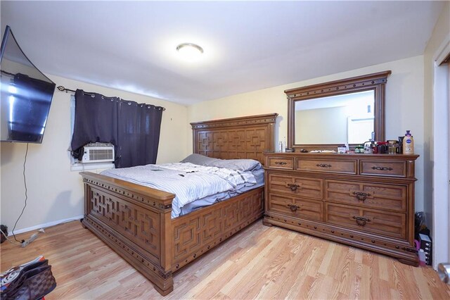 bedroom featuring cooling unit and light hardwood / wood-style flooring